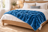 Blue Cosmic Wave throw styled across a bed