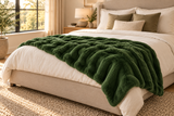Dark Green Cosmic Wave throw styled across a bed