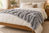 Light Gray Cosmic Wave throw styled across a bed